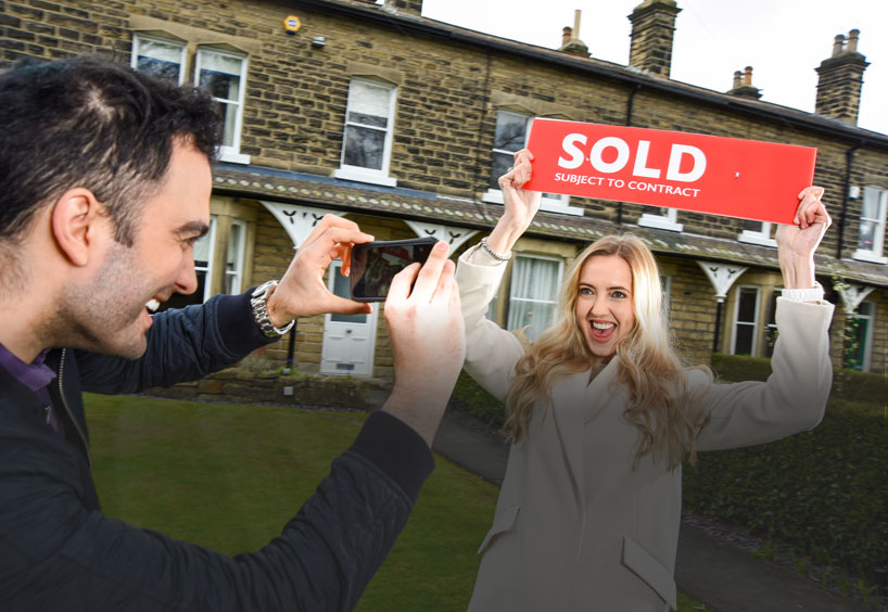 Couple with sold sign